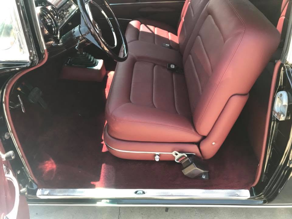 57 Chevy Custom burgundy leather bench seat with channel stitching and matching floor carpet in a 1957 Chevy by Central Valley Upholstery