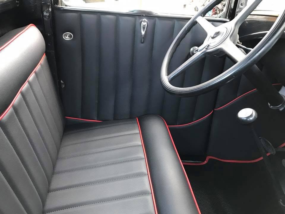 Ford Model A Custom black vinyl seats and door panels with red piping in a Ford Model A by Central Valley Upholstery