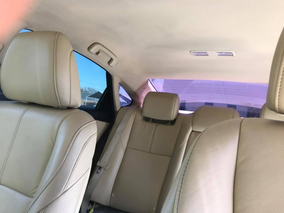 Custom tan leather headliner and rear seats installed in a modern sedan by Central Valley Upholstery