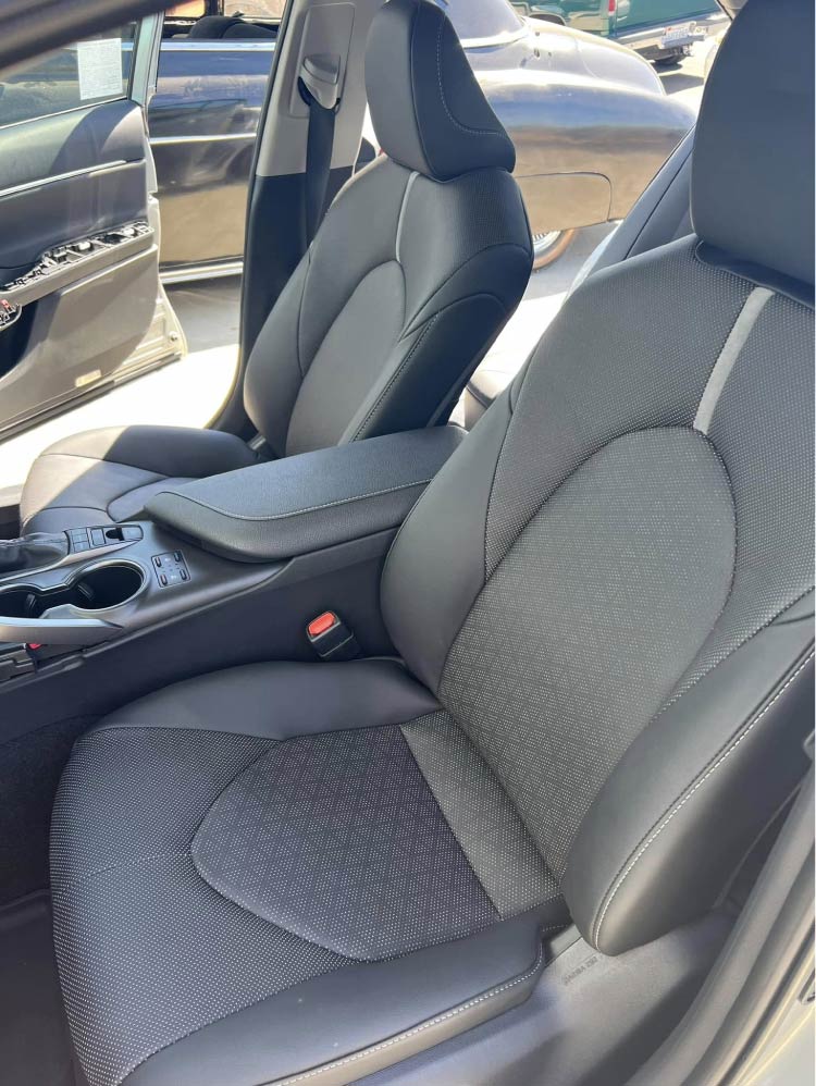 Custom tan leather bench seat with channel stitching and center console cup holders in a classic hot rod by Central Valley Upholstery