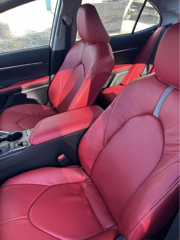 Custom red perforated leather car seats with contrast stitching installed in a Toyota by Central Valley Upholstery