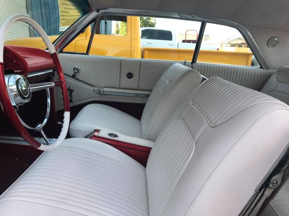 white vinyl Custom white vinyl bench seats and door panels with red dash in a restored 1964 Chevrolet Impala by Central Valley Upholstery