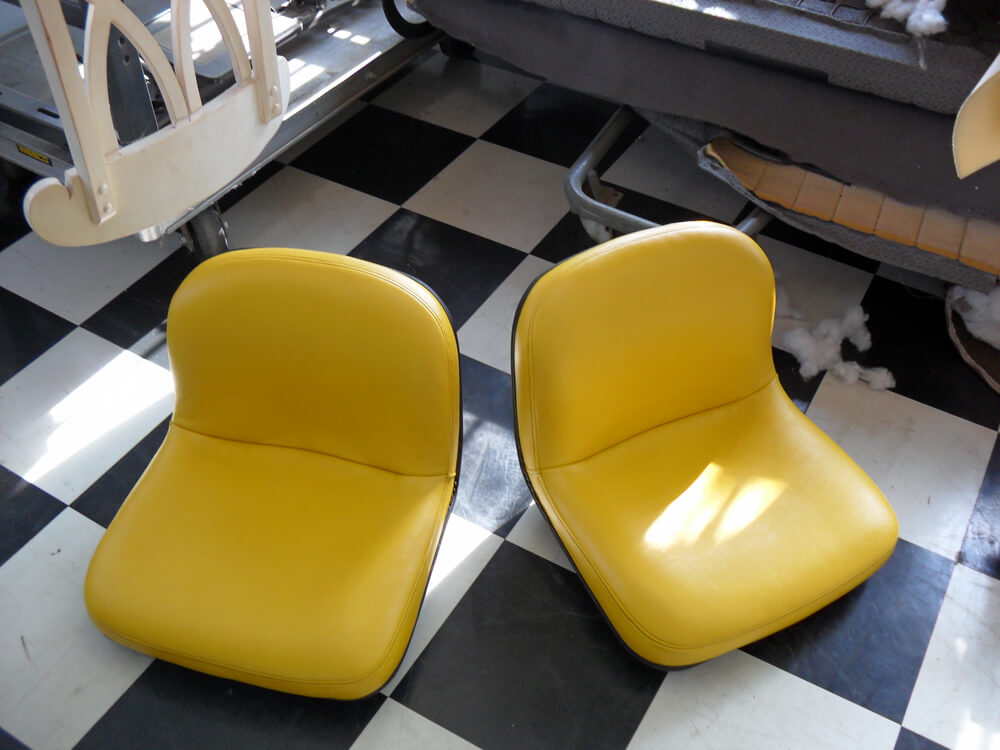 farm equipment upholsery (1) Custom yellow vinyl tractor and mower seats reupholstered by Central Valley Upholstery