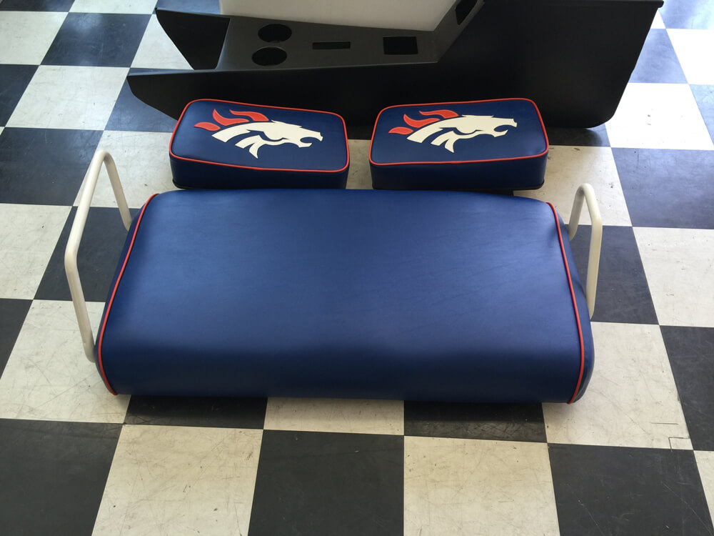 farm equipment upholsery (2) Custom navy blue vinyl bench seat with Denver Broncos logo cushions for farm equipment by Central Valley Upholstery