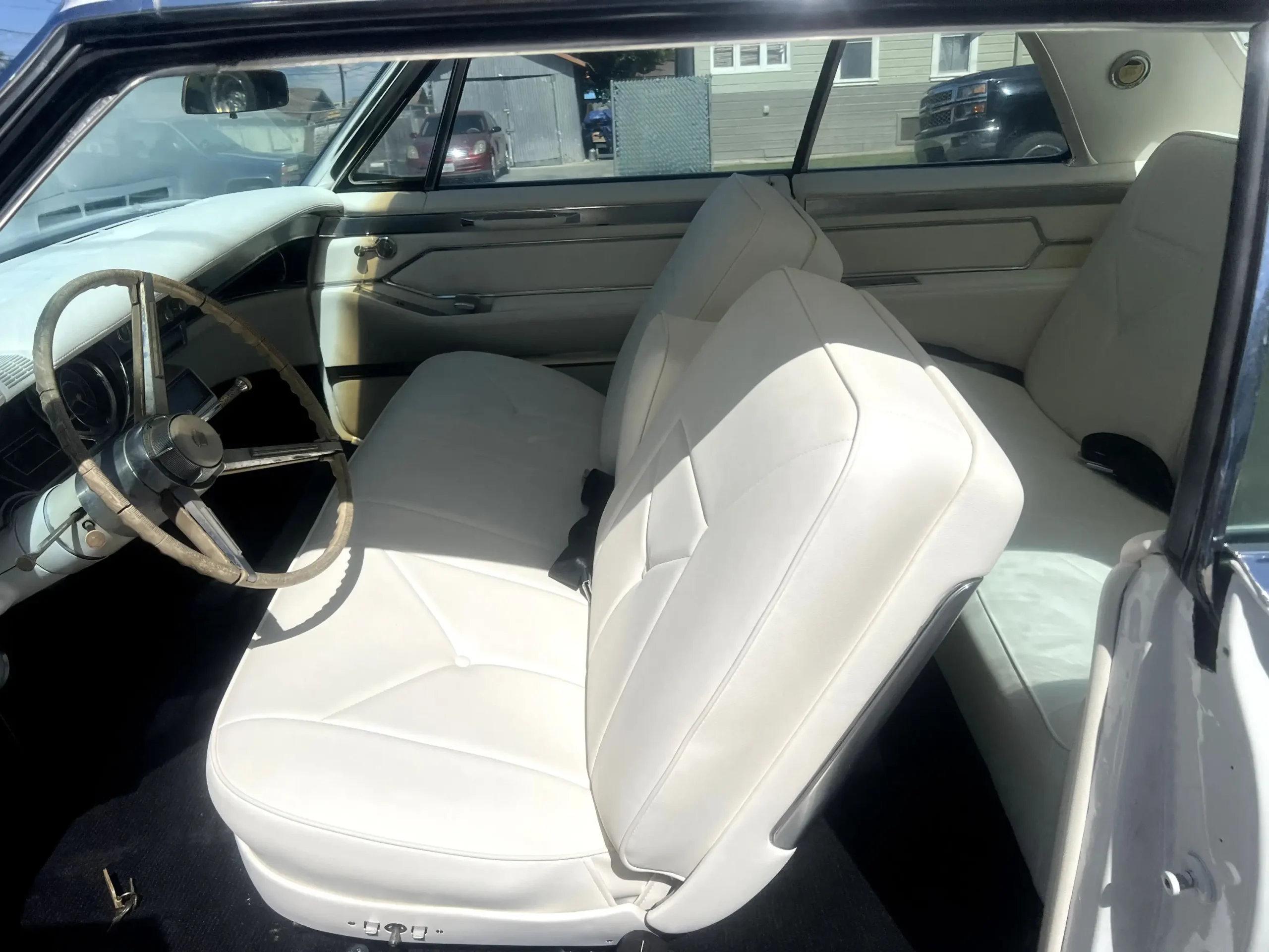 IMG_7823 (1) Custom cream leather bucket seats and center console with cup holders in a red 1955 Chevrolet Bel Air by Central Valley Upholstery